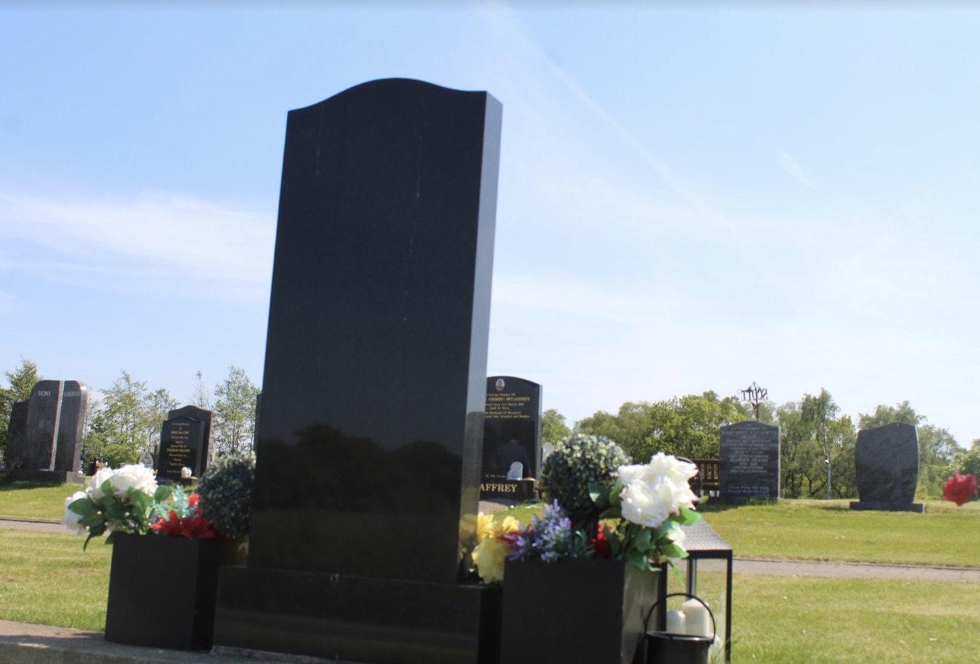 Polished black granite headstone in a Scottish cemetery
