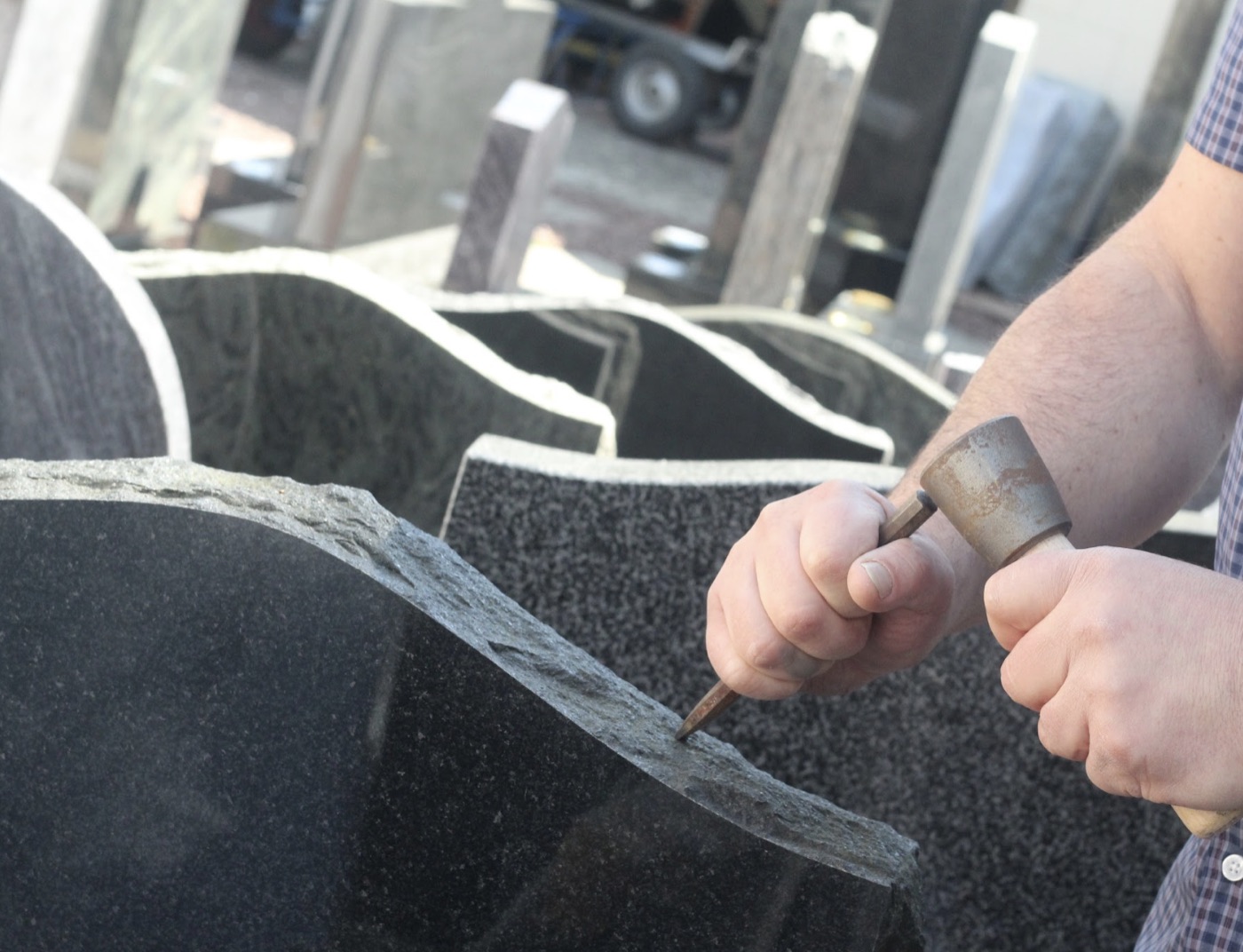 Rustic Scottish granite headstones with hand-pitched edges at the yard
